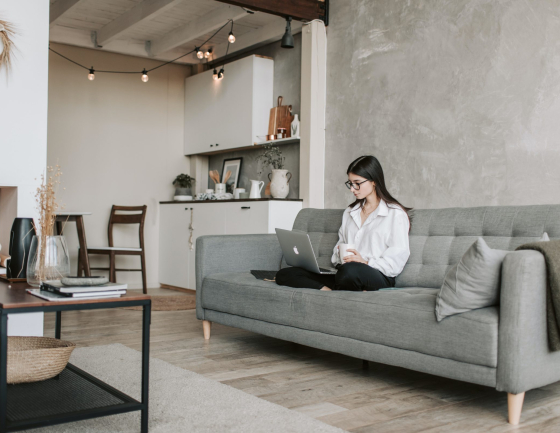 woman-sitting-on-a-sofa-while-working-with-laptop-4050293